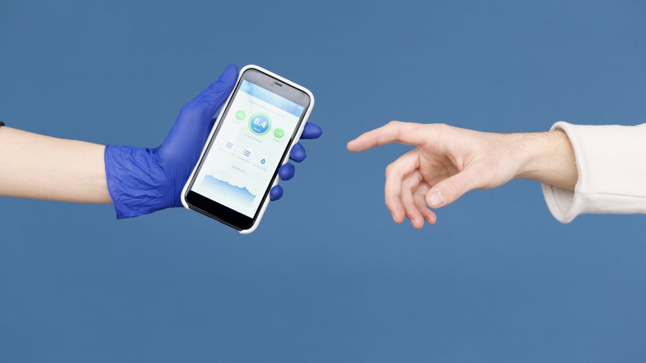 Conceptual image of hands reaching for smartphone with health app on blue background.